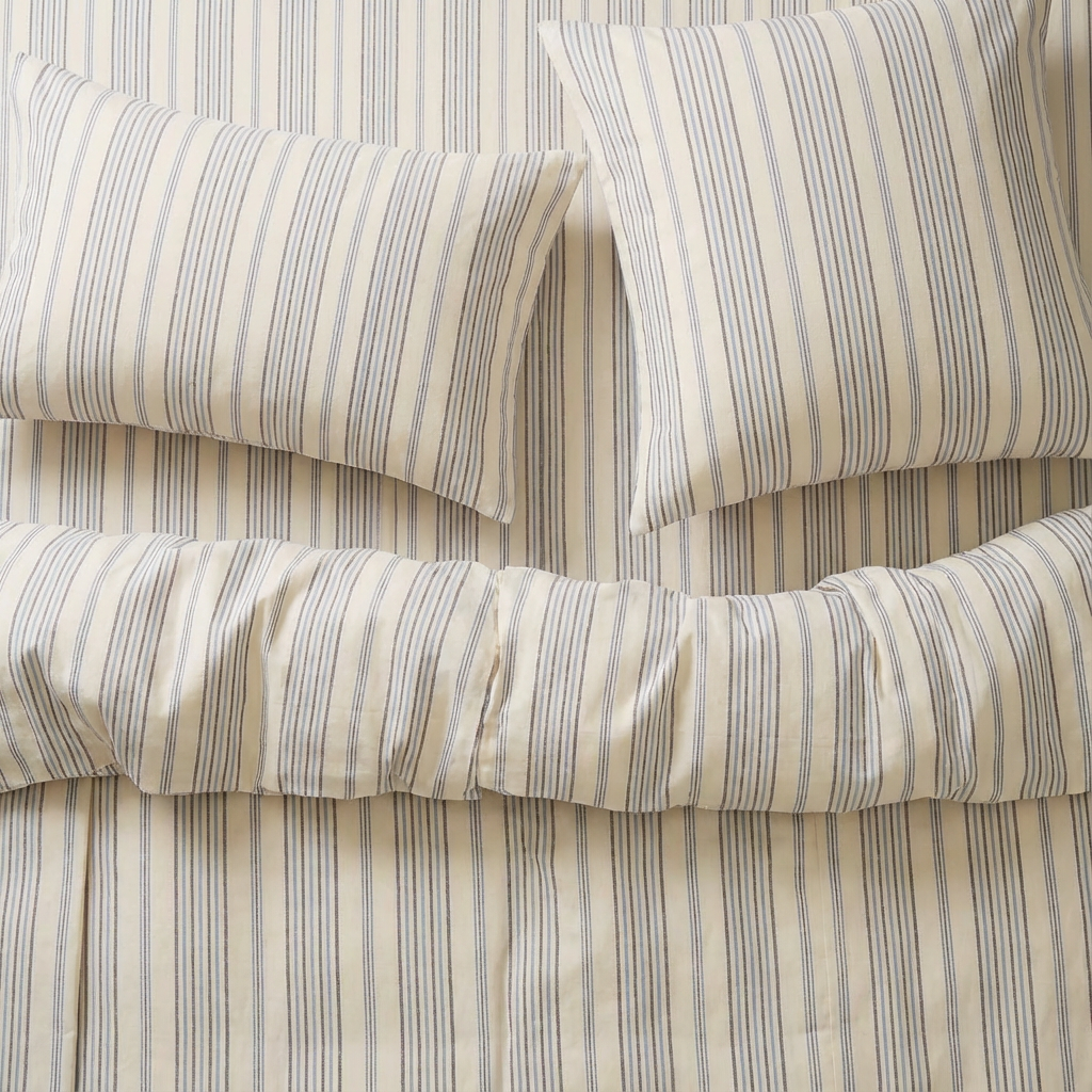 atelier orea blue Striped handwoven bedding set with pillows on a bed