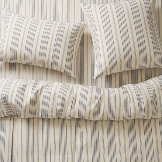 atelier orea blue Striped handwoven bedding set with pillows on a bed