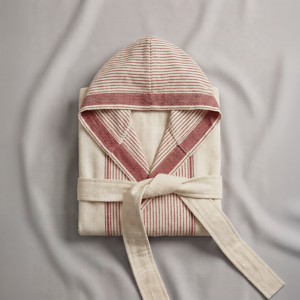 red Striped hooded atelier orea robe with a belt on a textured gray background