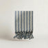 Baby blue striped turkish cotton towel with tassels on a light background from atelier orea