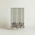 Handwoven slub cotton striped atelier orea towel with tassels on a light background