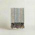 Textured handwoven slub turkish cotton atelier orea towel with frayed edges on a light background