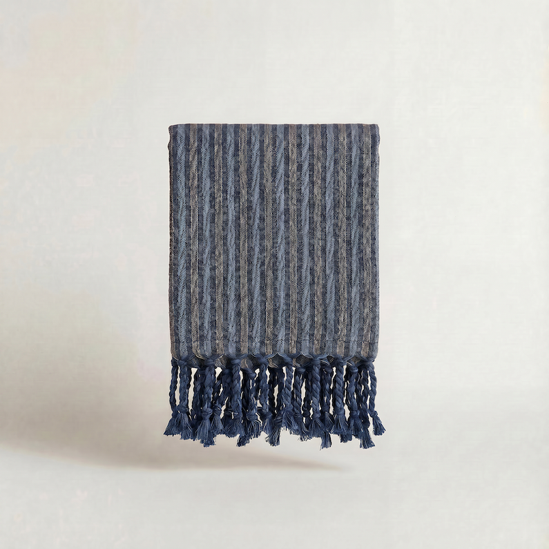 Handwoven turkish cotton towel navy brown striped with tassels on a light background