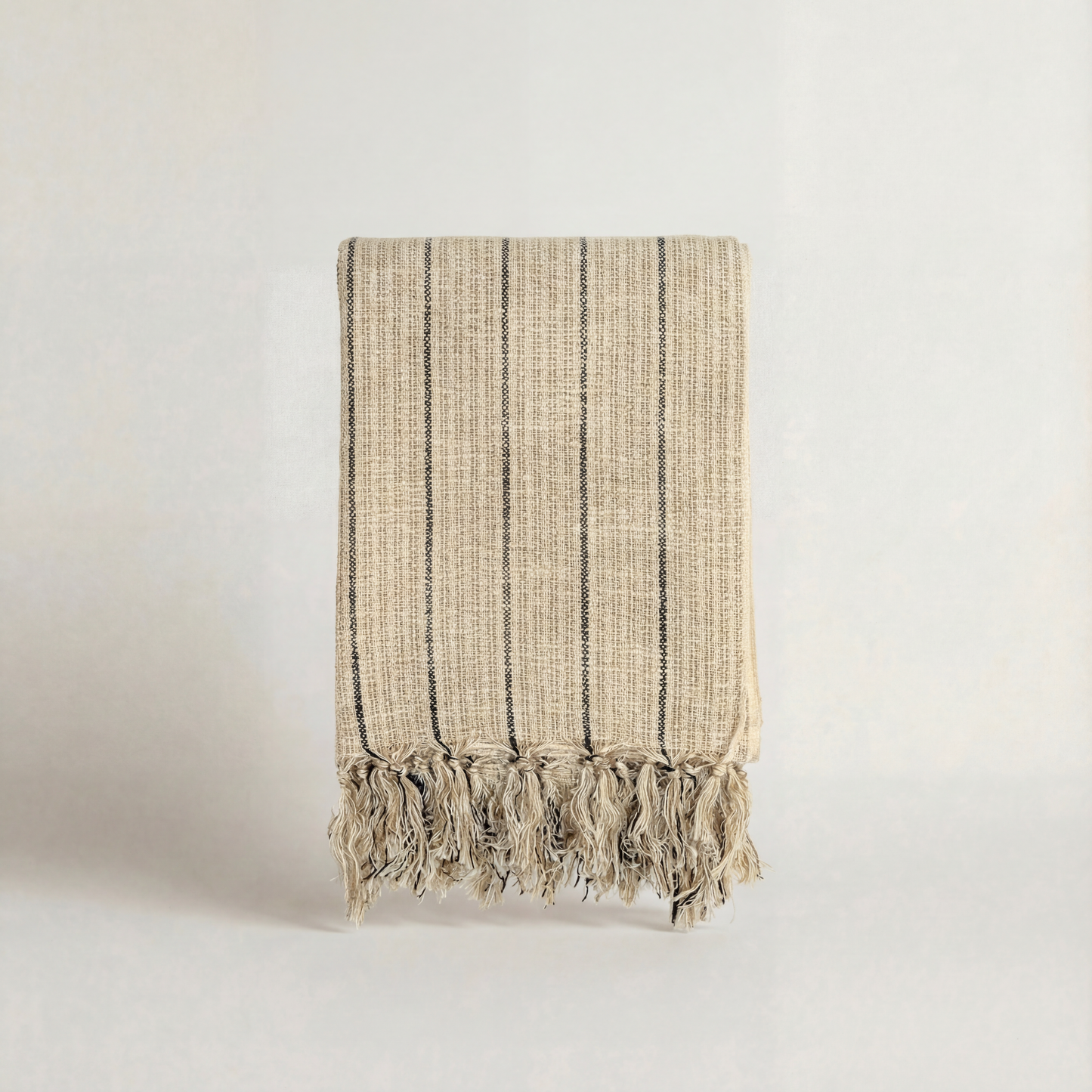 Textured handwoven atelier orea towels with fringes on a light background