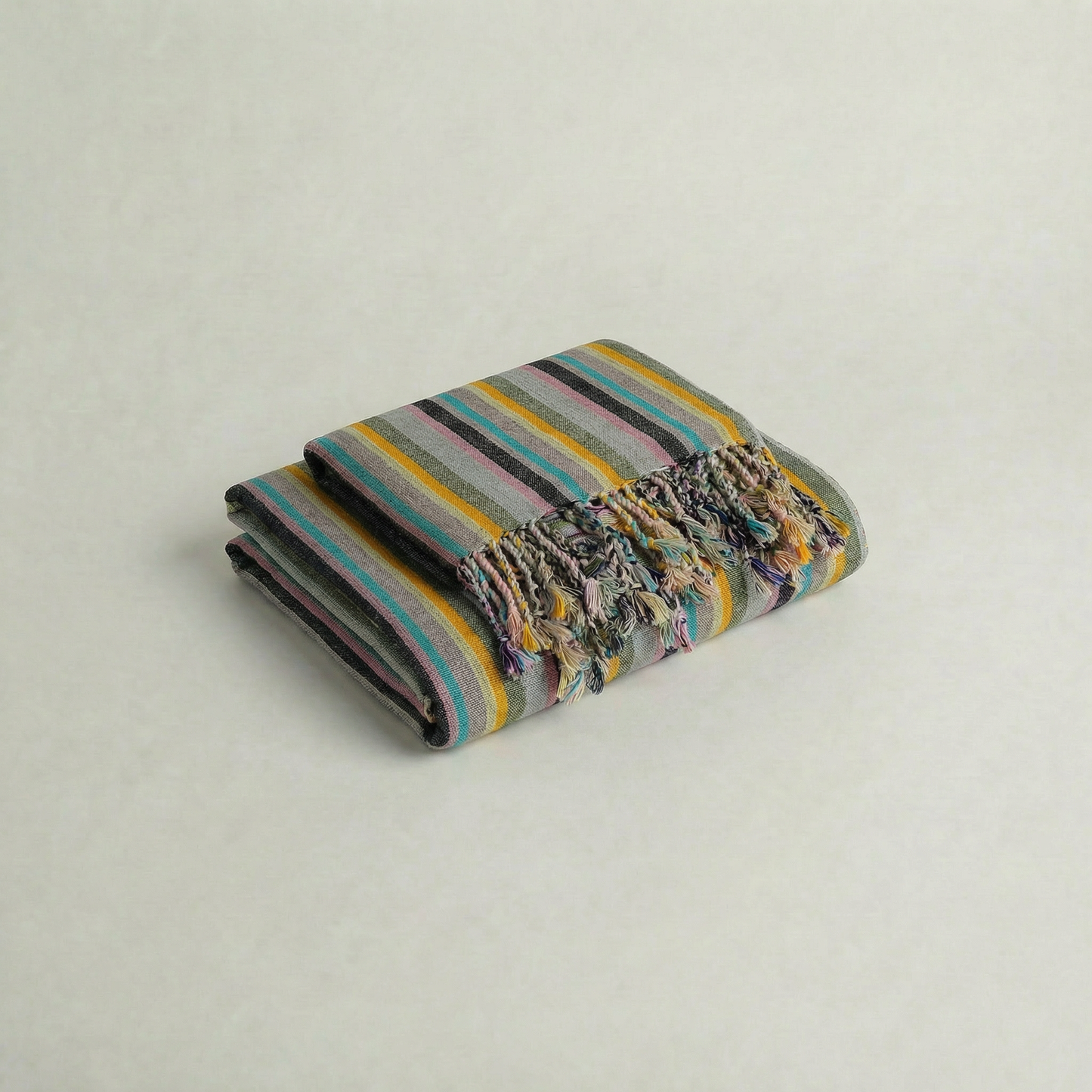 Handwoven linen cotton atelier orea towel with colorful pattern on a light gray background