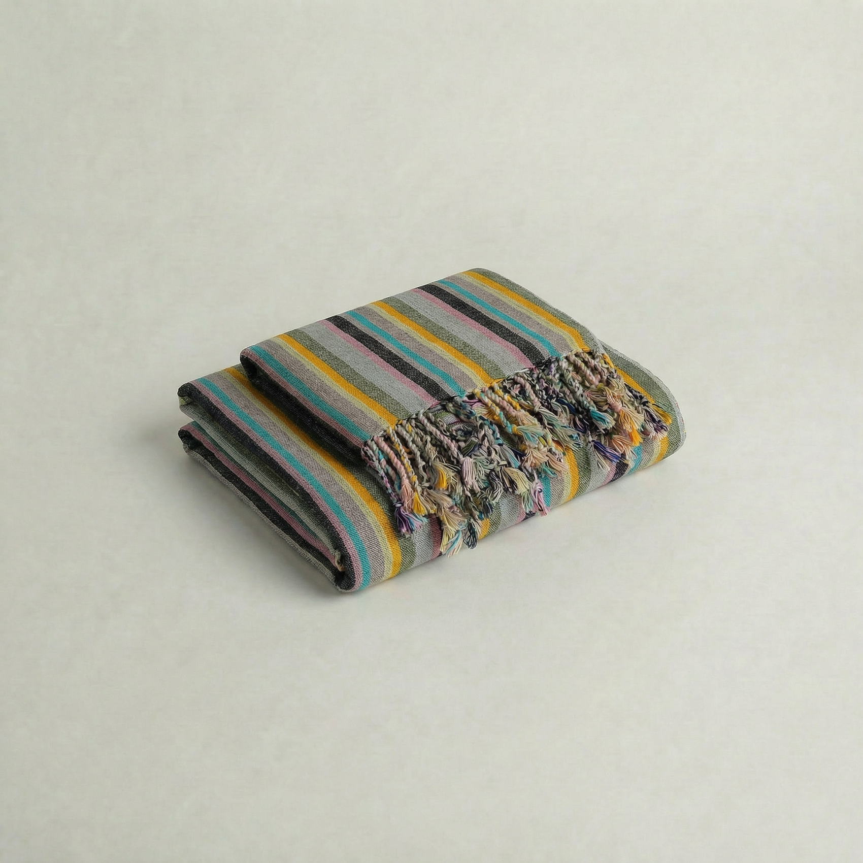 Handwoven linen cotton atelier orea towel with colorful pattern on a light gray background