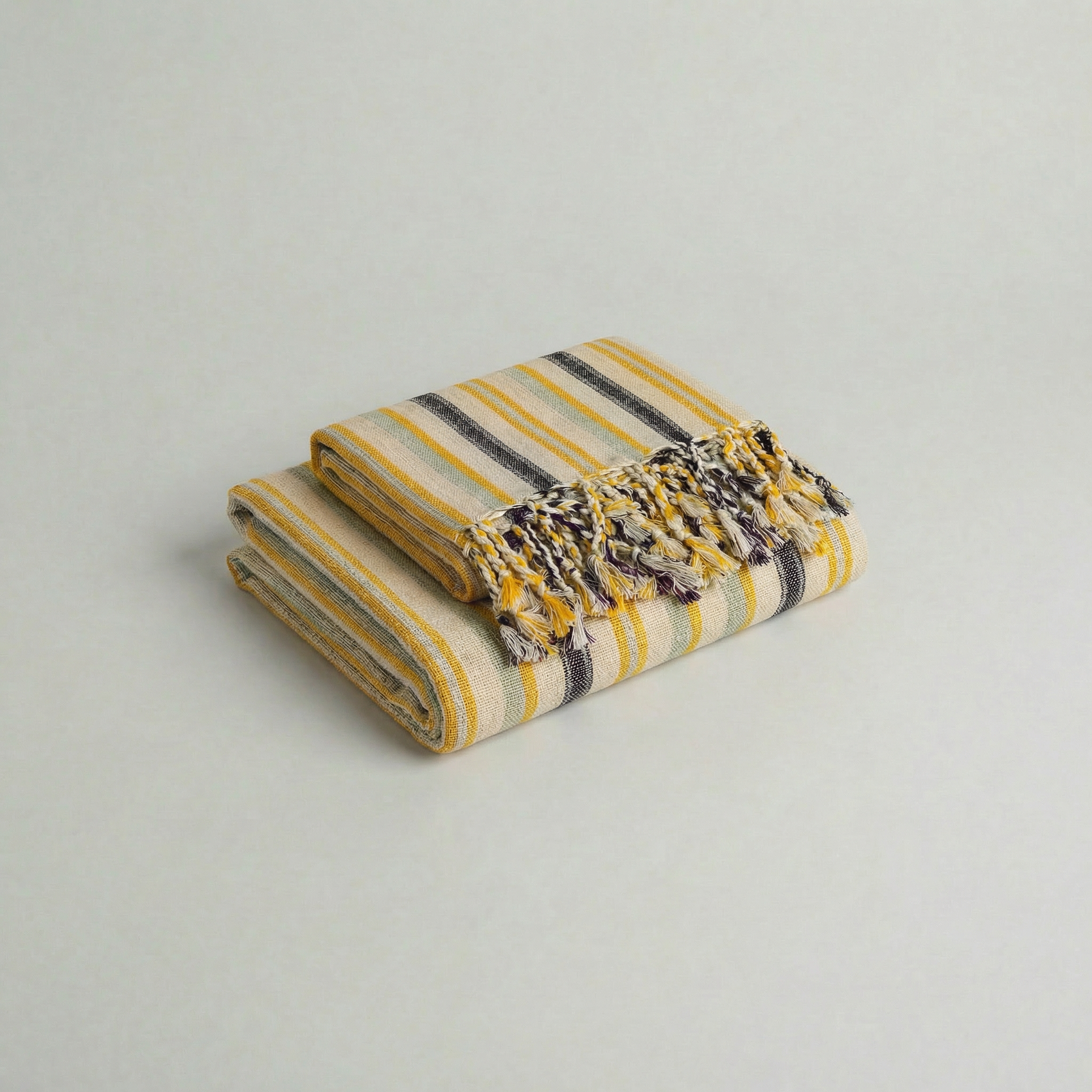 Folded atelier orea handwoven cotton towel set in yellow, mint green and purple